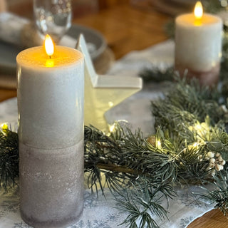 Decorative candles on a table with a festive setting