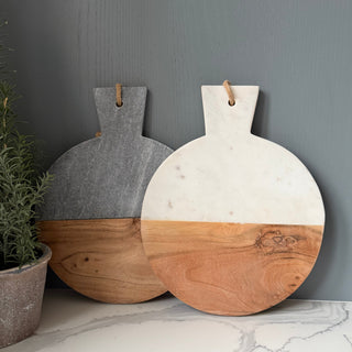 Two wooden cutting boards with marble-like finishes on a gray surface.