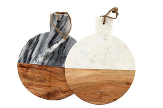 Two round chopping boards, one with a marble pattern and the other with a wooden pattern, both have a handle resembling a rope tied to the edge.