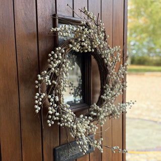 white berry wreath on oak door 