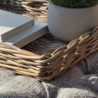 Close-up of a textured surface with woven material and a gray fabric.