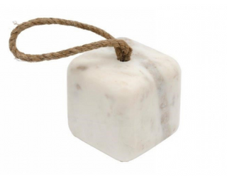 A white marble door stop with grey patterns and a jute rope attached to it for pulling.