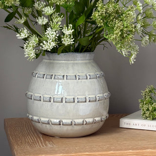 Decorative vase with floral arrangement on a wooden surface