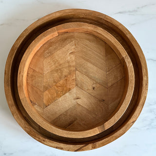 Stack of wooden tray on a marble surface