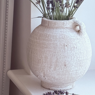 white terracotta vase close up on shelf